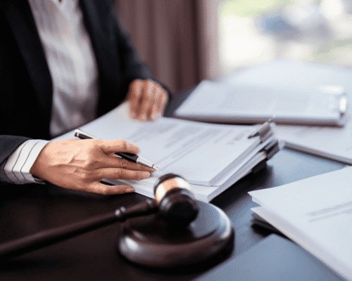 Lawyer reviewing legal documents on desk with gavel