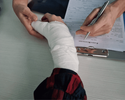 Injured person with bandaged arm filling out medical form