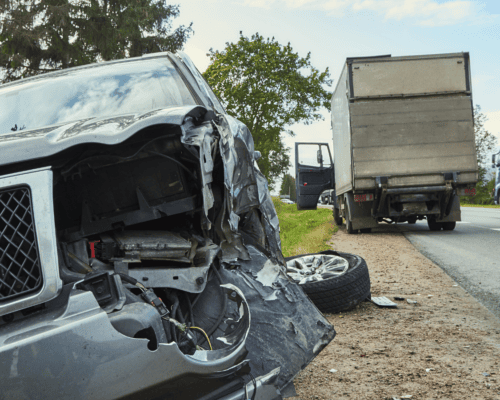 Damaged vehicle and commercial truck on a roadside in Columbus, Georgia, illustrating a truck accident scene and the importance of documenting medical expenses for a personal injury claim.