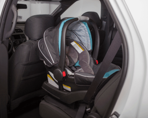 Empty infant car seat securely fastened in the back seat of a vehicle, representing product liability cases involving defective children’s products and how Georgia parents can pursue legal action for injuries caused by unsafe or recalled baby gear.